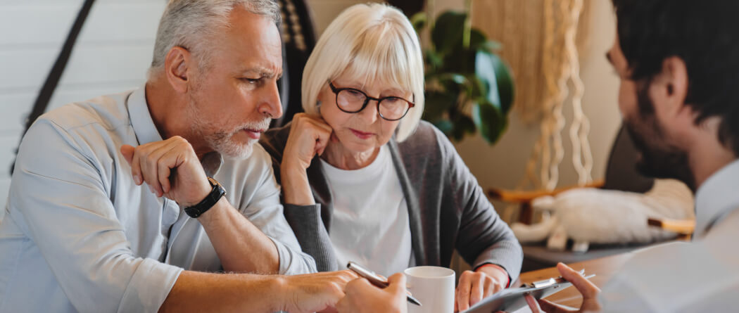 a mature couple reviewing documents