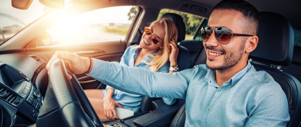 a couple riding in their new automobile