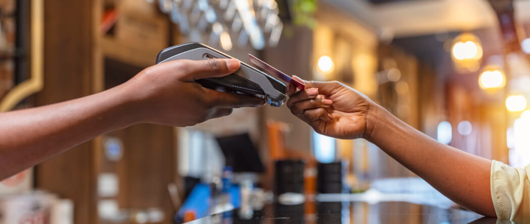 a person paying with their debit or credit card