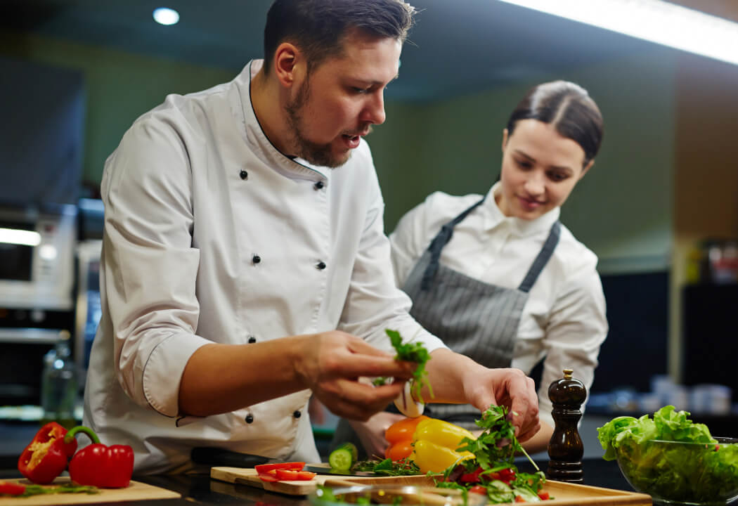 Two chefs in an industrial kitchen