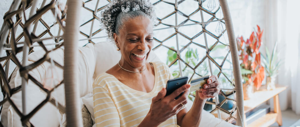 a woman making a mobile purchase with her credit or debit card