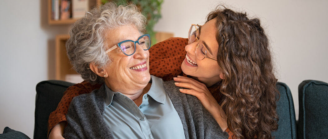 a mother and daughter smiling